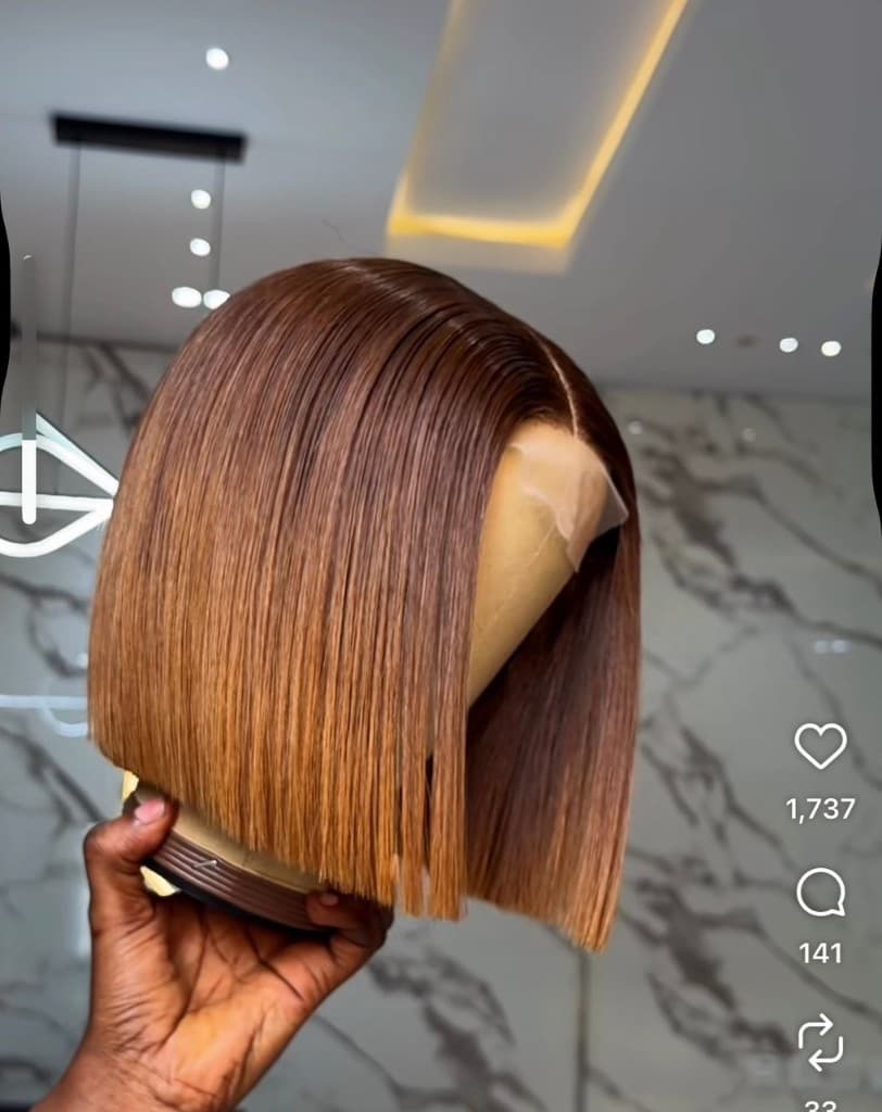 Honey brown straight lace front bob wig with middle part and blunt cut on a mannequin