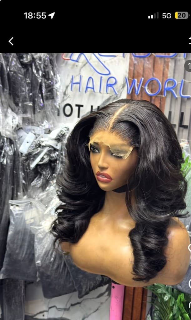 Voluminous body wave lace front wig with middle part and visible HD lace on a mannequin